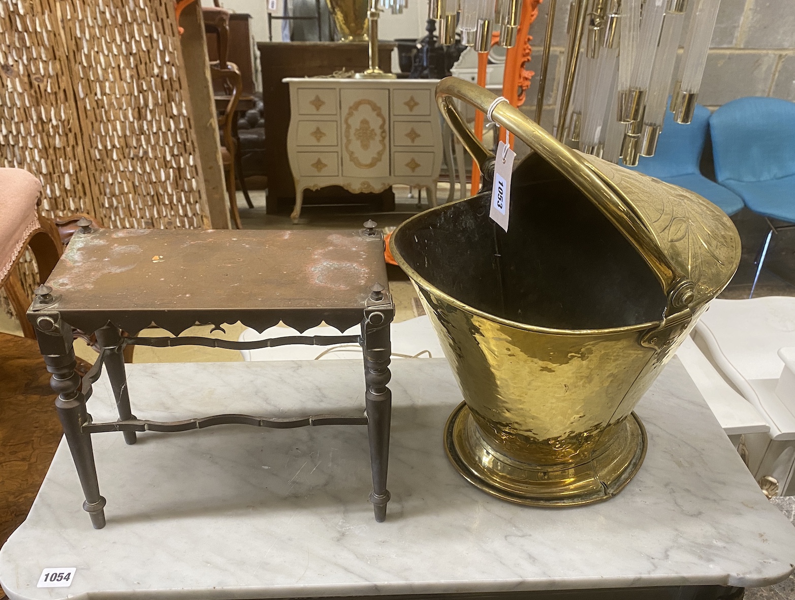 A 19th century Dutch embossed brass coal scuttle with swing handle together with a Victorian copper trivet